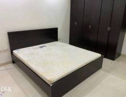 Bed with matress and cupboard