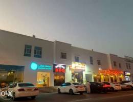 Shops in Al Khoudh main Street next to high brand cafes and restaurant